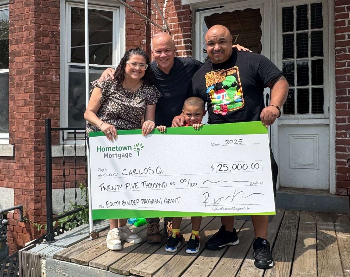 Carlos with Mortgage Lender, Harry Montalvo holding a large check grant donation!